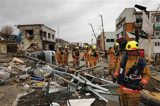 Members of a Fairfax County, Va. search and rescue team walk through a damaged area as they search for tsunami survivors in Ofunato, Japan on March 15.