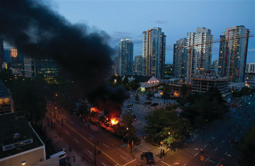 Smoke plumes rise from police cars set on fire following the Vancouver Canucks being defeated by the Boston Bruins in the NHL Stanley Cup Final in Vancouver on June 15.