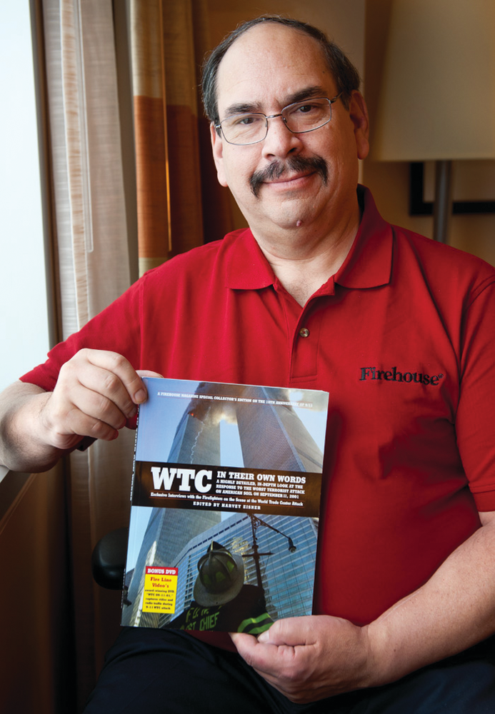 Firehouse Magazine Editor Harvey Eisner poses with a copy of his new book 'WTC In Their Own Words.'