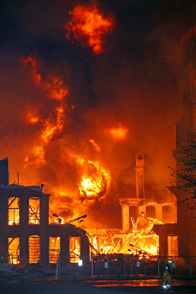 Heavy timbers that once supported the center portion of the mill's floors and an outside wall collapsed and produced a large fire ball that rolled upwards into the sky.