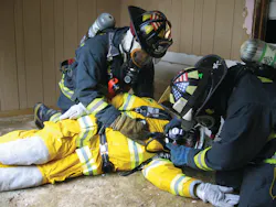 Figure 1. Realistic scenario-based training is a must for rapid intervention, but this also necessitates a closer eye be kept on safety of the participants. Here, firefighters practice assessment and changing over of an air supply, skills that often are neglected during training, but require emphasis. Figure 1. Realistic scenario-based training is a must for rapid intervention, but this also necessitates a closer eye be kept on safety of the participants. Here, firefighters practice assessment and changing over of an air supply, skills that often are neglected during training, but require emphasis.