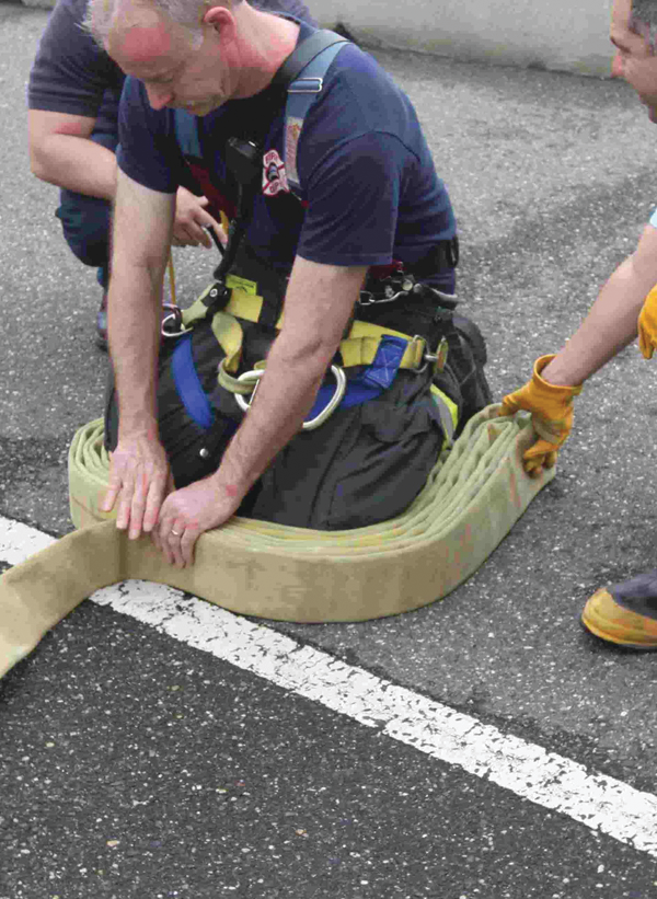 Photo 1. When packing the first hose pack, start with the female coupling at your left ankle and continue to go from one ankle to the other.