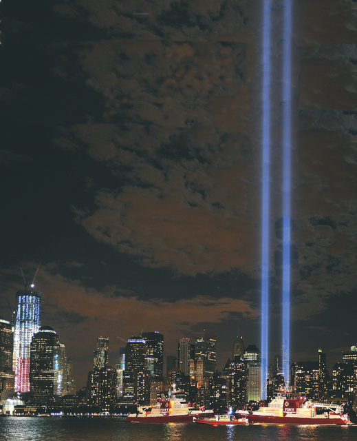 The new 1 World Trade Center, at left of photo, has reached the 80th-floor level. New York City&rsquo;s three newest fireboats line up in the Hudson River as memorial lights shine skyward in honor of the 10th anniversary of those killed during the 9/11 terror attacks.
