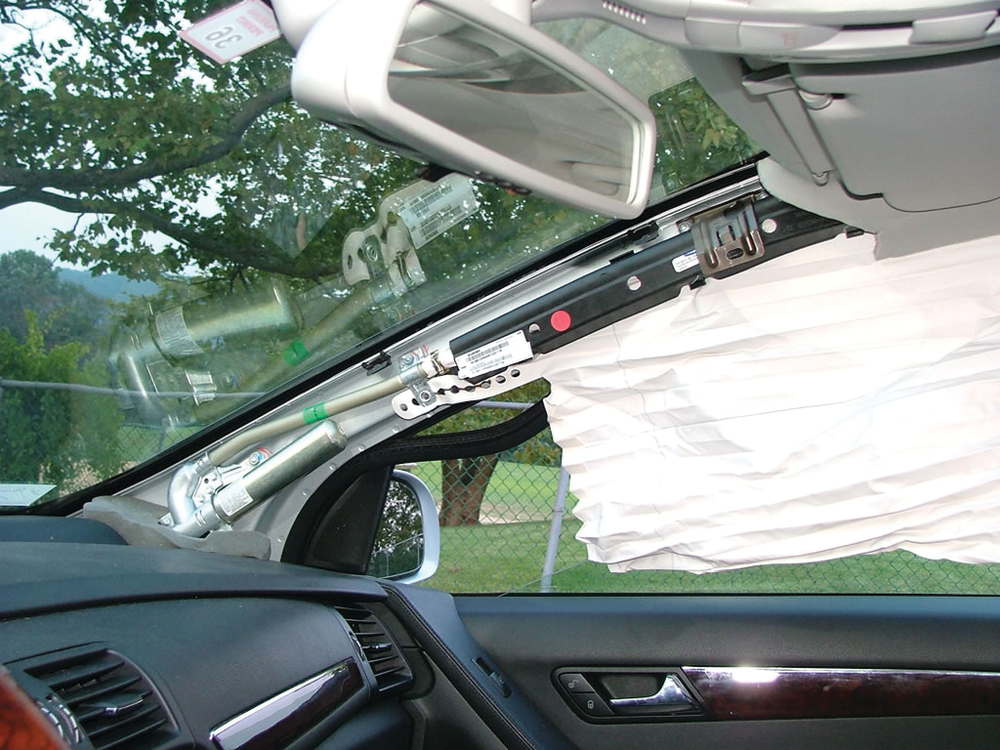 The location of stored gas inflators for roof airbag systems may complicate efforts to cut through an A-pillar. When flapping the roof forward, the A-pillar remains intact. Photo by Ron Moore