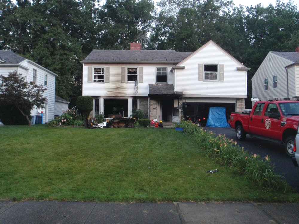 Upon arrival of the first-due engine and truck companies, light smoke was showing from this house and an occupant was leaning out of a second-floor window.
