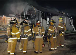 A rapid intervention team stands ready at a house fire in Fort Worth, TX. A rapid intervention team stands ready at a house fire in Fort Worth, TX.
