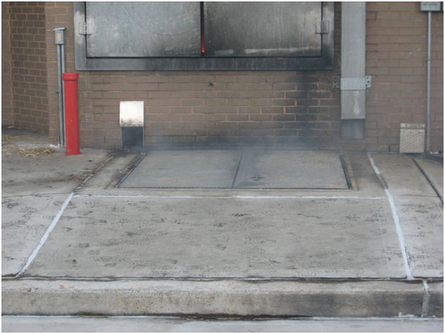 Photo 1. Bulkhead doors can be found at various levels of the building. Here it is built right into the street.