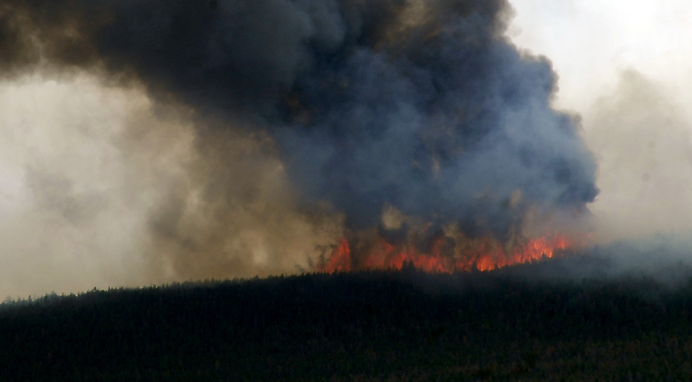 Smoke billows from a wildfire burning west of Fort Collins, Colo. on June 12.