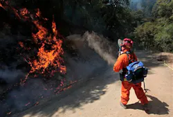 An inmate firefighter from the Eel River Conservation camp throws dirt on flames from the Robbers Fire near Iowa Hill, Calif. on July 12. An inmate firefighter from the Eel River Conservation camp throws dirt on flames from the Robbers Fire near Iowa Hill, Calif. on July 12.