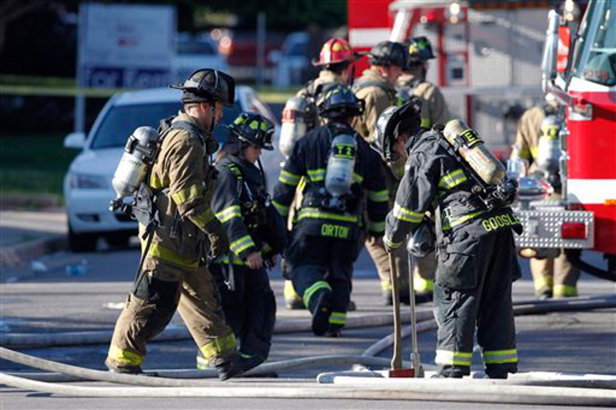 Firefighter work in front of an apartment where the suspect in a theatre shooting lived in Aurora, Colo. on July 20.