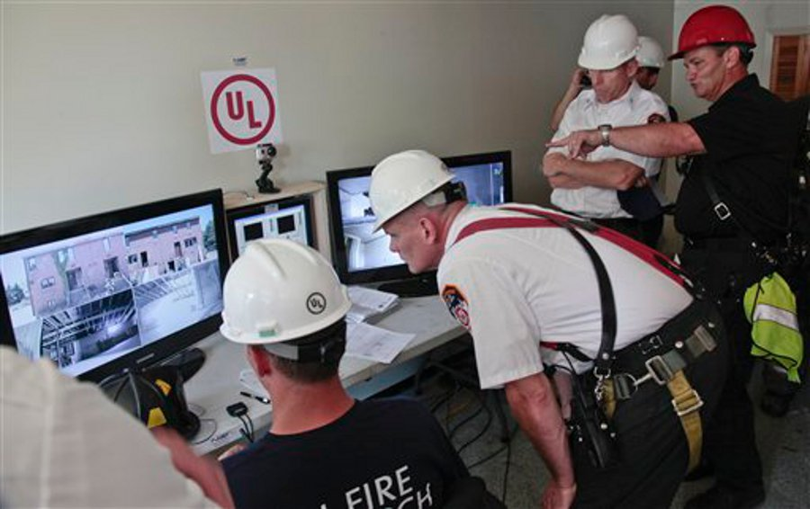 FDNY officials watch live camera feeds from a controlled blaze on Governors Island on July 3.