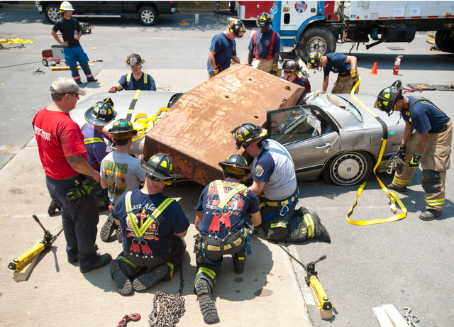 Attendees learn about extrication techniques used during heavy vehicle extrication incidents during hands on training in Columbia.