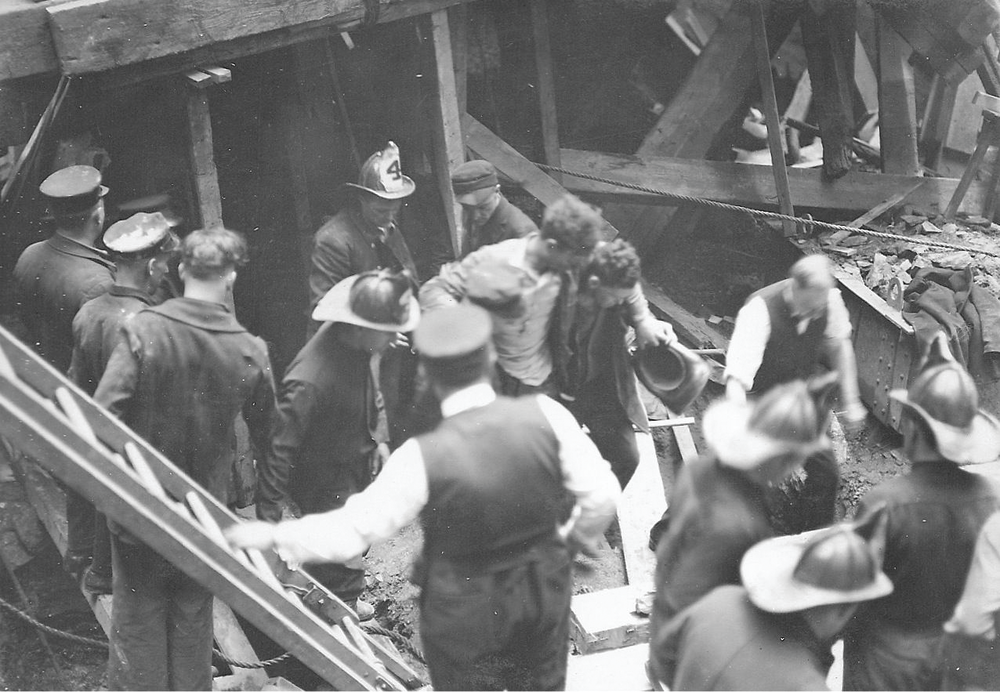 NEW YORK CITY, MAY 24, 1924 &ndash; Members of FDNY Ladder 4 and Rescue 1 help remove an injured worker after a cave-in occurred in the subway.