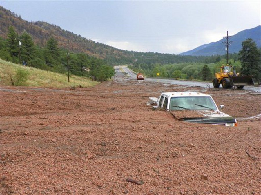 A pickup truck is engulfed by a mudslide on U.S. 24 west of Cascade, Colo. on July 30.