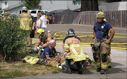Paramedics tend to Forest Grove Capt. Joe Smith, who injured his leg trying to stop a man from running into a burning room, on Aug. 9. Paramedics tend to Forest Grove Capt. Joe Smith, who injured his leg trying to stop a man from running into a burning room, on Aug. 9.
