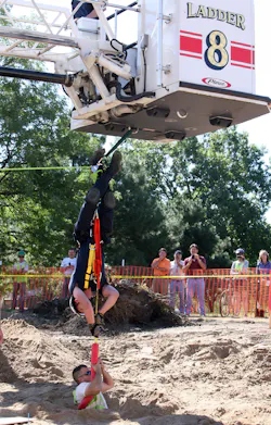 A St. Paul firefighter pulls a construction worker up after he fell down a hole on Aug. 20. A St. Paul firefighter pulls a construction worker up after he fell down a hole on Aug. 20.