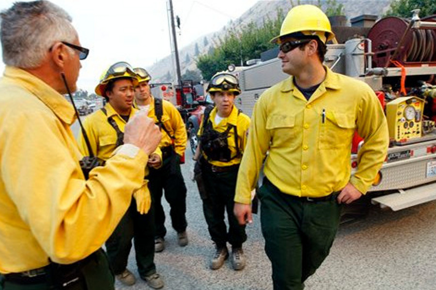 Firefighters get instructions as they ready to head toward a wildfire on Sept. 10 near Wenatchee, Wash.