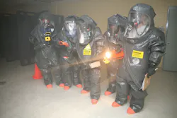Responders prepare to enter a room and use devices that detect for the presence of chemical, biological, and radiological material during the revised 40-hour class in Anniston, AL. Responders prepare to enter a room and use devices that detect for the presence of chemical, biological, and radiological material during the revised 40-hour class in Anniston, AL.