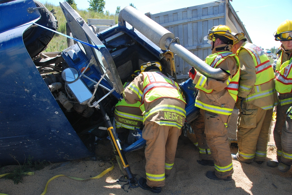 Crews work to remove the driver from the rig.