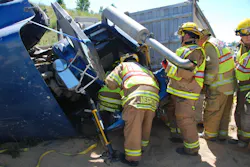 Crews work to remove the driver from the rig. Crews work to remove the driver from the rig.