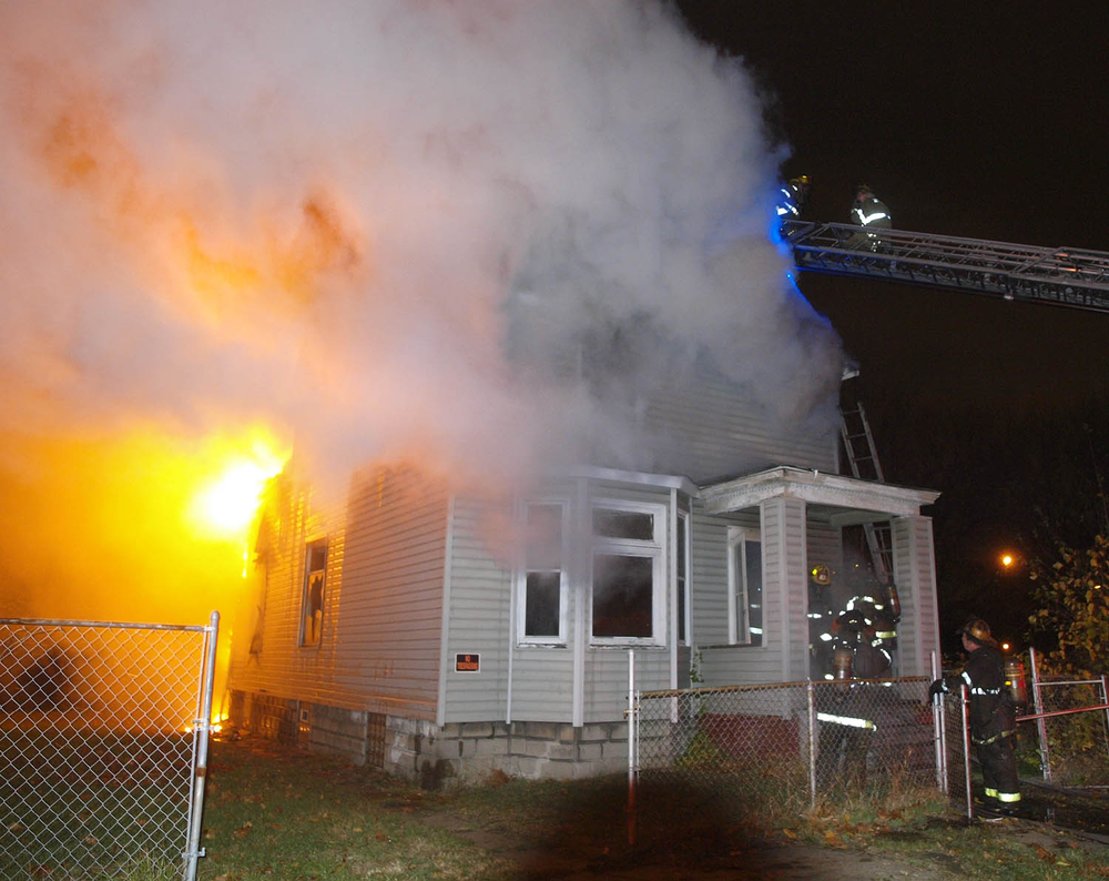 Detroit firefighters are seen battling a house fire during a relatively calm Angels' Night period due to Superstorm Sandy and volunteer efforts.