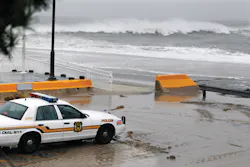 A police officer watches from his patrol car as the rough Atlantic Ocean threatens streets on Oct. 29 in Cape May, N.J. A police officer watches from his patrol car as the rough Atlantic Ocean threatens streets on Oct. 29 in Cape May, N.J.