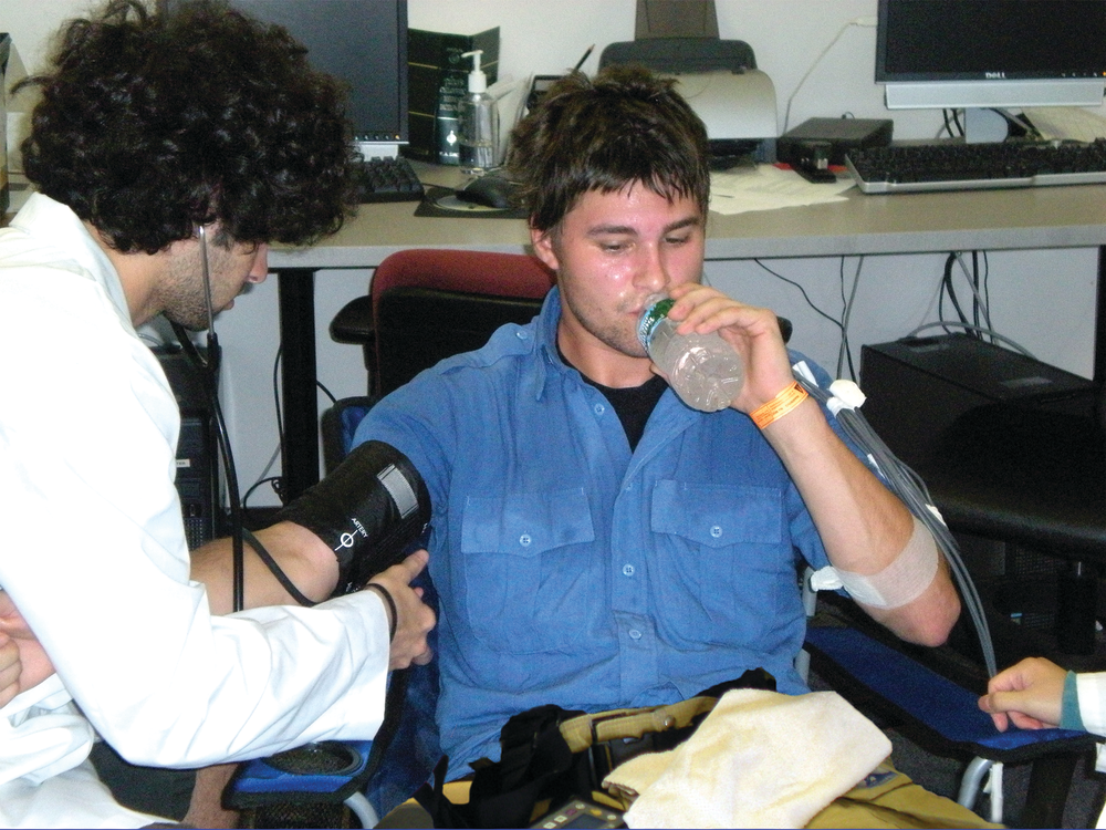 Figure 1. During treadmill walking, participants wore full personal protective equipment (PPE). During recovery periods, participants doffed their helmet, gloves, hood and bunker coat and sat in front of a fan and rehydrated. This participant was wearing a cotton T-shirt and a station uniform under the PPE.