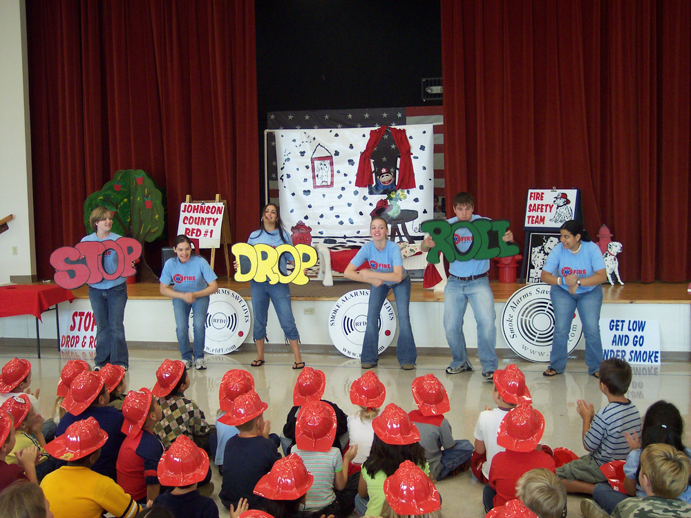 Members of the Johnson County Rural Fire Department #1 Fire Corps team help with fire prevention education at a local school.