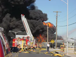This is a photo I took of firefighters setting up at the scene of a three-alarm tire fire. This is a photo I took of firefighters setting up at the scene of a three-alarm tire fire.