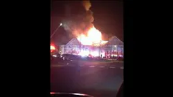 Flames from apartment building lick the night sky. Flames from apartment building lick the night sky.