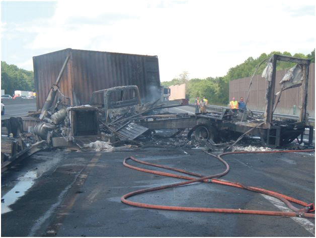 Photo 10 - The trailer in the foreground has been completely burned away, while the intermodal container has stayed relatively intact. Heat exposure still requires a thorough overhaul of the trailer's contents.