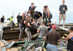 A victim is removed from Oklahoma tornado debris. A victim is removed from Oklahoma tornado debris.