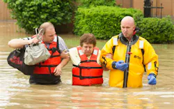 Fort Wayne firefighters Jerry Shultz, left, and Brian Sorgen, right, help Karen Hudda wade through the flood waters in front of her West State Blvd. home on Saturday, June 1, 2013 in Fort Wayne, Ind. Fort Wayne firefighters Jerry Shultz, left, and Brian Sorgen, right, help Karen Hudda wade through the flood waters in front of her West State Blvd. home on Saturday, June 1, 2013 in Fort Wayne, Ind.