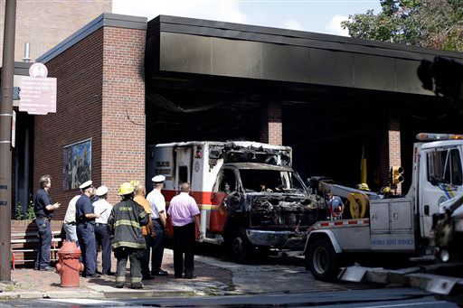 The burnt hulk of a medic unit is towed from the the Engine 8, Ladder 2 firehouse Friday, Sept. 27, 2013, in the Old City neighborhood of Philadelphia.