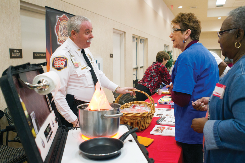 Las Vegas Fire & Rescue Public Education & Information Officer Timothy R. Szymanski talks with Marlene Moran during a Senior Safety Fair in October. Senior citizens were taught how to prevent fires and how to escape safely should a fire occur.