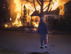 A frustrated resident waiting for companies to arrive, watches as three vacant houses burn on the East Side. A frustrated resident waiting for companies to arrive, watches as three vacant houses burn on the East Side.