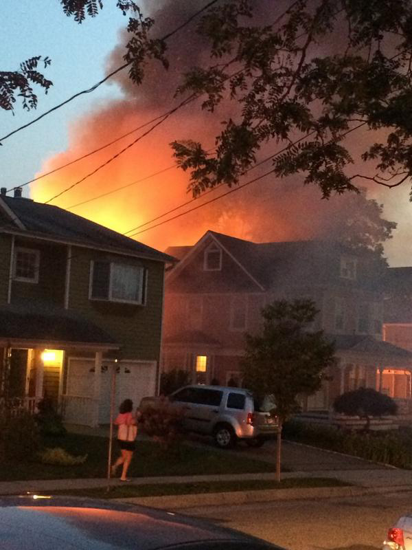 Flames engulf a structure in Port Washington, N.Y., Tuesday night.