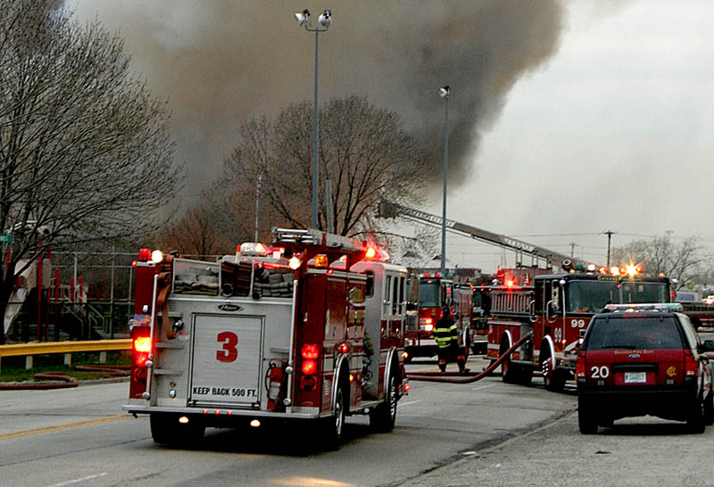 Apparatus, especially engines, arriving on the scene of multiple alarms, should consider backing to better position themselves if they have to go to work. In this instance, since the engine in the foreground did not lay a supply line, it is in a relatively useless position if they are ordered to provide additional lines without a lot of additional maneuvering. The engine right behind it has backed in, and will be able to quickly stretch lines if needed.