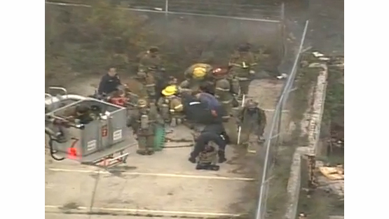 Firefighters and medics tend to the injured firefighters in Detroit Wednesday morning.