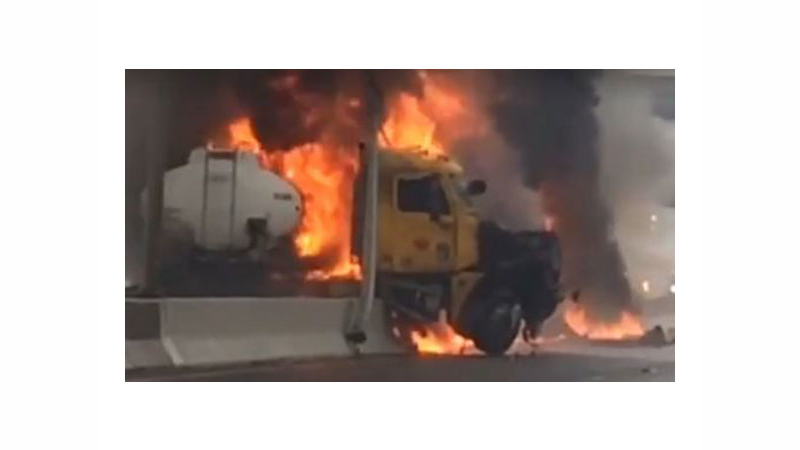 Video captured the driver of a tanker, whose head can be seen in this screengrab, escaping from his burning rig.