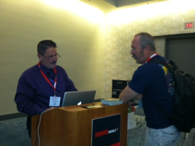 Ret. Deputy Chief of LA County Fire Mike Bryant, left, talks to a firefighter.