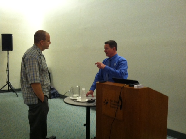 Chief Peter Van Dorpe, right, talks with a student following his pre-conference class on Monday.