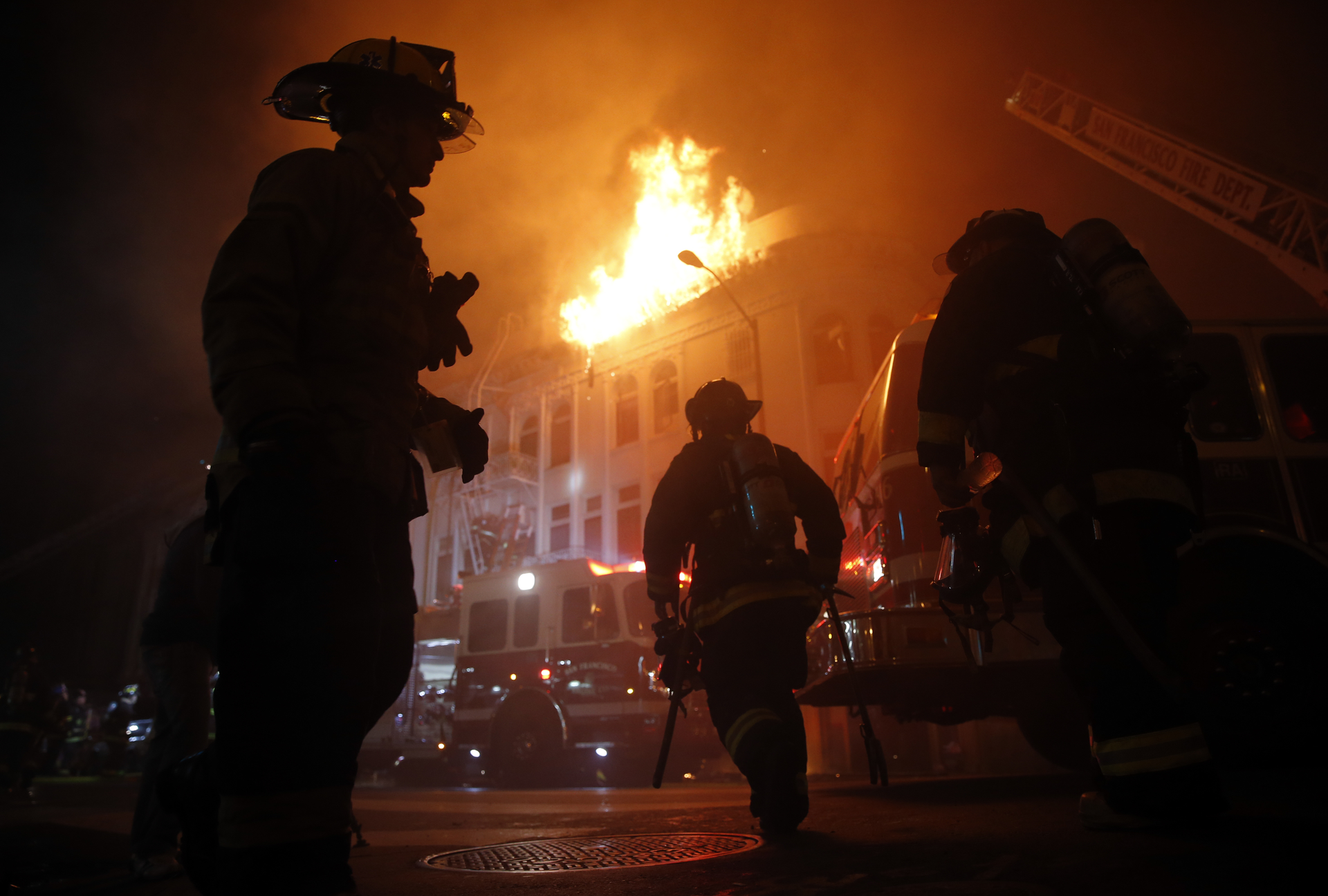 San Francisco Fire Department members fight a four-alarm fire at 22nd and Mission Street in San Francisco, Calif., on Wednesday, Jan. 28, 2015.