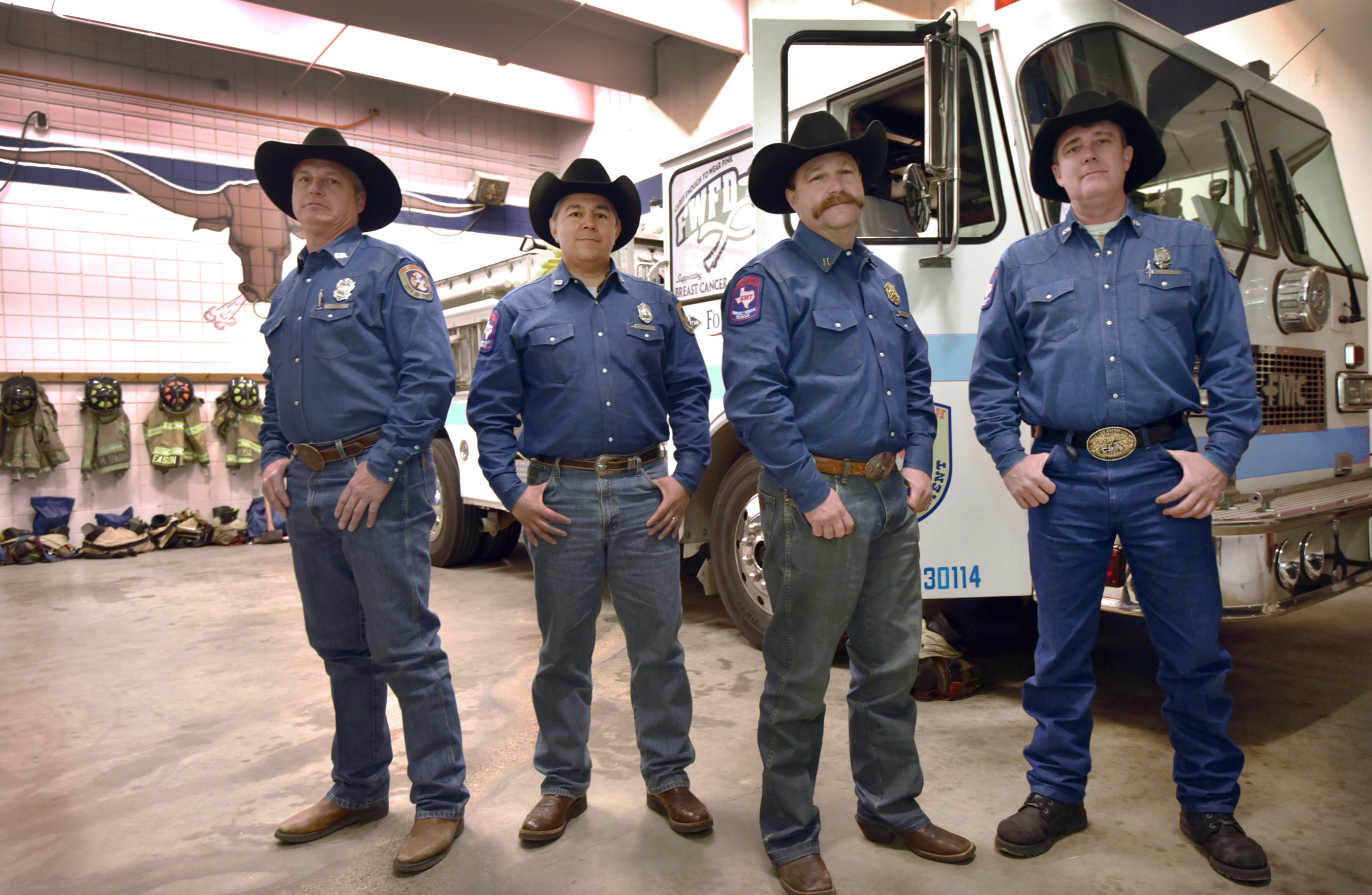 Fort Worth firefighters Rohn Renfro (left to right), Mark Espinosa, Capt. David Collard and Todd Brook pose in their uniforms while working at Station 80 last week.