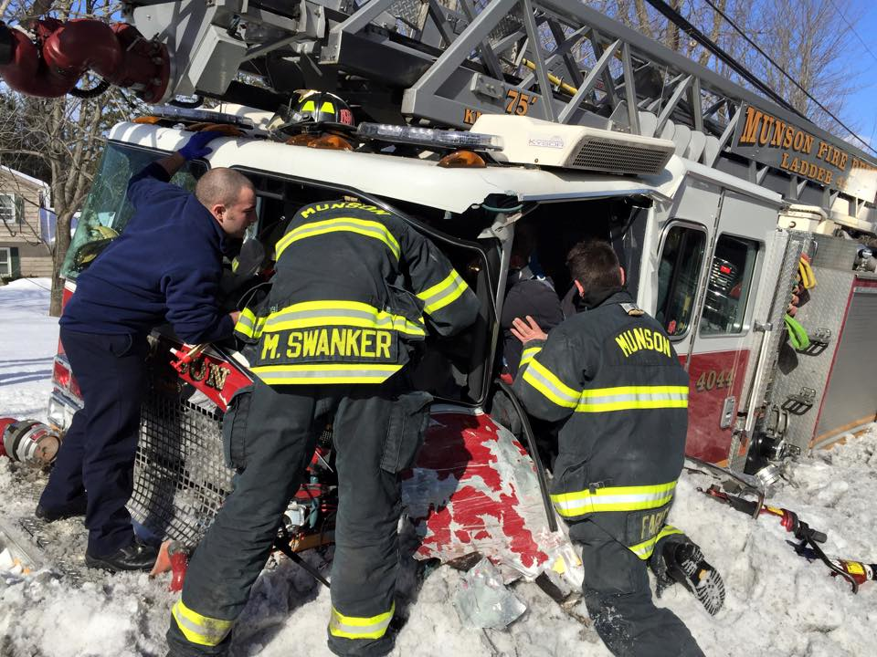 Firefighters attempt to free one of their own.