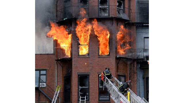 Boston firefighters work a multi-alarm brownstone fire that claimed Lt. Edward Walsh and Firefighter Michael Kennedy on March 26, 2014.