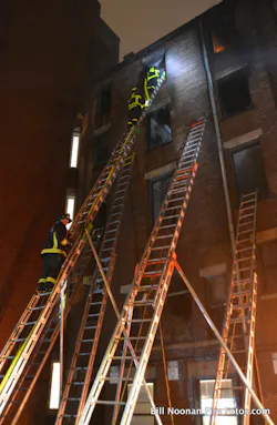 The Boston Fire Department makes great use of 50-foot ground ladders. Shown here is a laddering job in the rear of a 5-story building, inaccessible to apparatus, that could only have been done with the 50 footers. The Boston Fire Department makes great use of 50-foot ground ladders. Shown here is a laddering job in the rear of a 5-story building, inaccessible to apparatus, that could only have been done with the 50 footers.