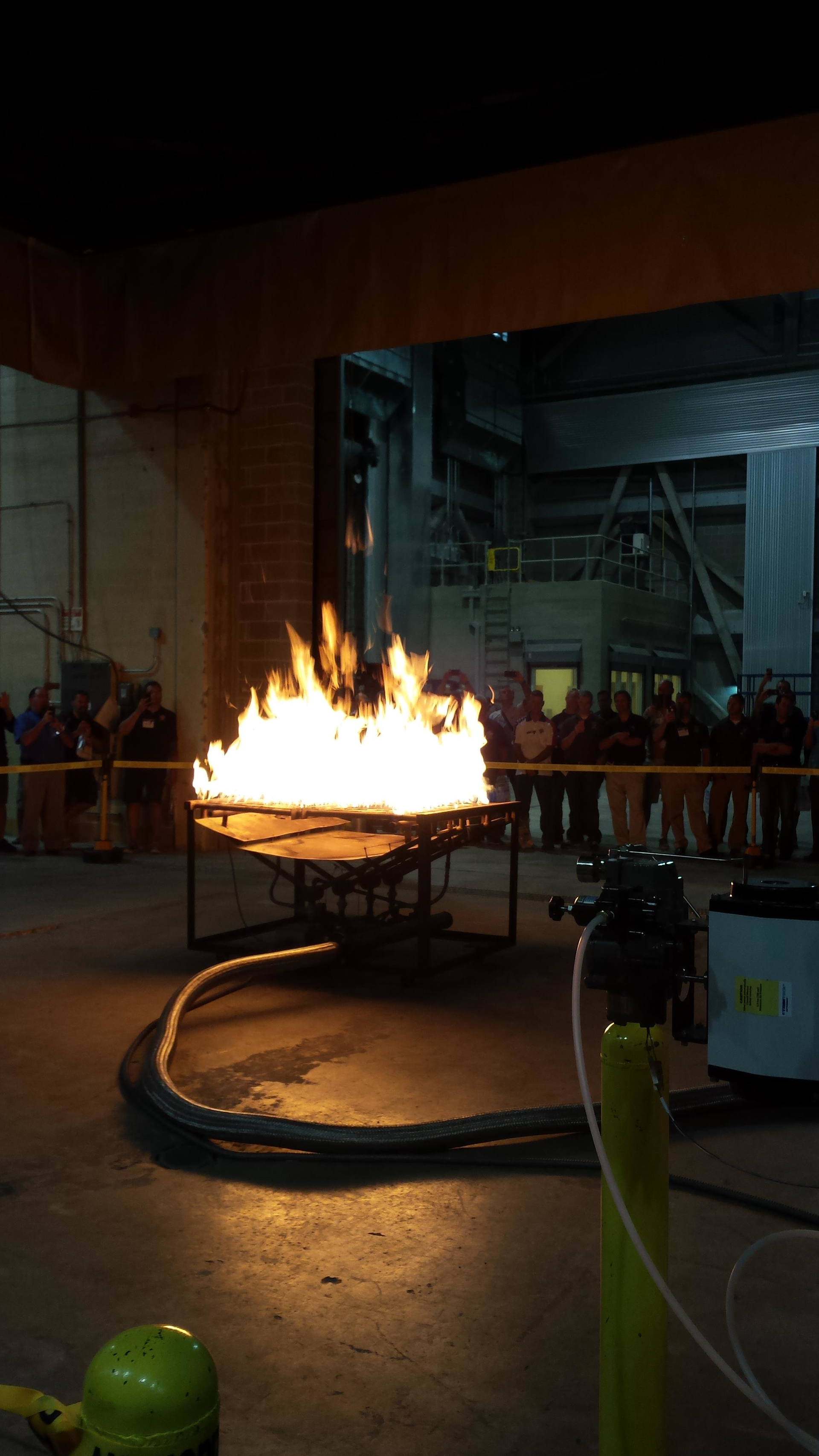 Firefighters watched an experiment in a NIST lab.