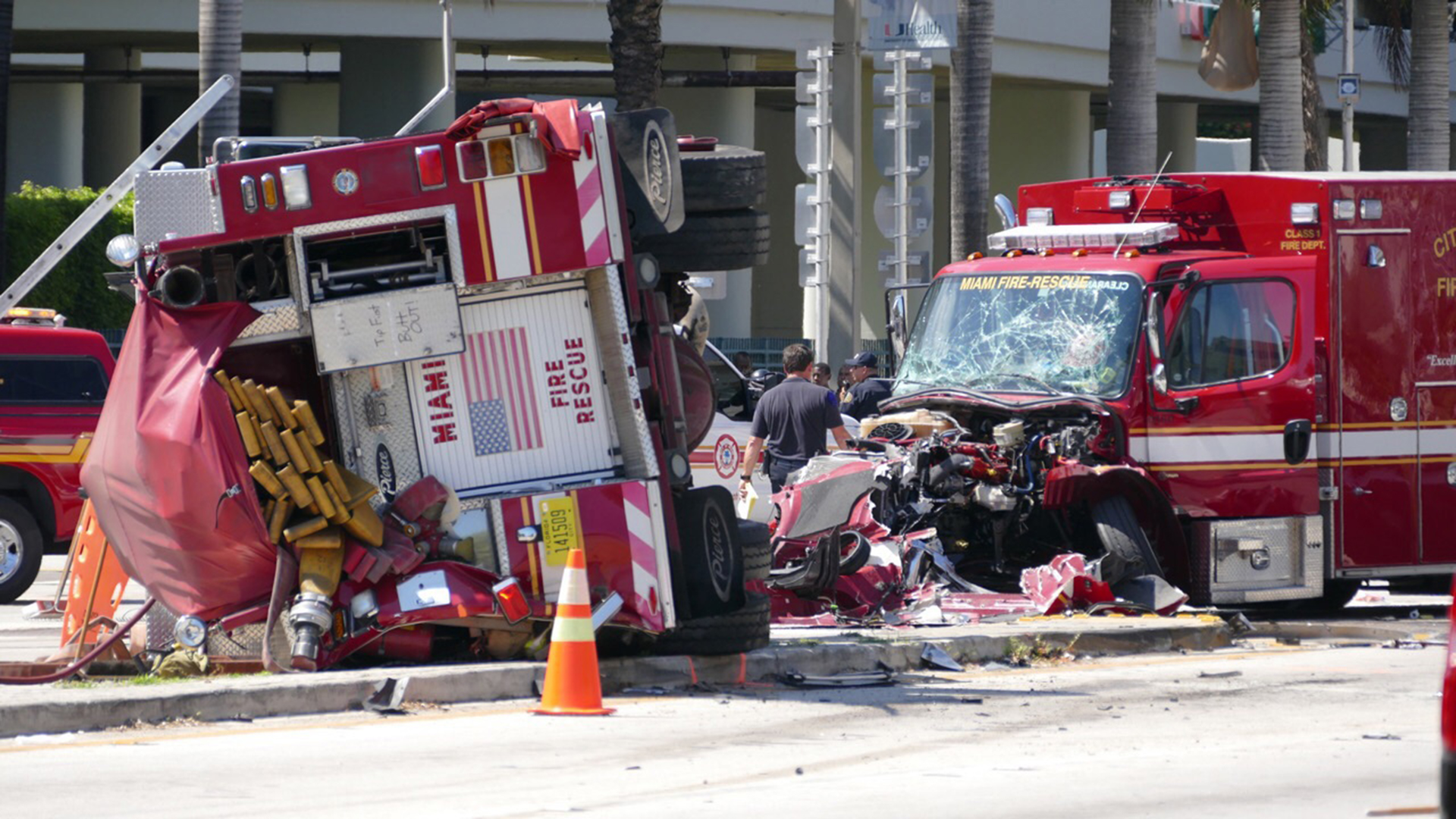 Officers and rescue personnel work on the scene of a major crash involving two fire trucks in Miami on Tuesday, Aug. 11, 2015. The crash happened near the Jackson Memorial Hospital complex as both vehicles were rushing to a call.