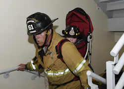 A very young future firefighter gets a lift. A very young future firefighter gets a lift.